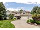 Inviting home exterior featuring a curved driveway, well-manicured lawn, and a two-car garage at 5301 S Birch Ct, Greenwood Village, CO 80121
