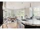 Bright and airy kitchen with a granite island, stainless appliances, and view into the dining area at 5301 S Birch Ct, Greenwood Village, CO 80121