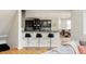 Modern kitchen featuring a breakfast bar with seating, dark cabinetry, and stainless steel appliances at 5301 S Birch Ct, Greenwood Village, CO 80121