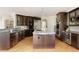 Well-equipped kitchen showcasing dark cabinetry, stainless appliances, granite counters, and a center island at 5301 S Birch Ct, Greenwood Village, CO 80121