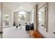 Bright living area with a large arched window and access to a balcony via glass paneled double doors at 5301 S Birch Ct, Greenwood Village, CO 80121