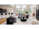 Open-concept living room with large windows, comfortable sectional sofa, and stylish decor at 5301 S Birch Ct, Greenwood Village, CO 80121
