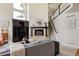 Bright living room features a fireplace, staircase, large windows, and comfortable seating at 5301 S Birch Ct, Greenwood Village, CO 80121
