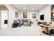Spacious living room with a large sectional sofa, decorative pillows, and a mounted television at 5301 S Birch Ct, Greenwood Village, CO 80121