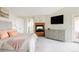 Comfortable main bedroom featuring a fireplace, TV, dresser, and access to an outdoor area at 5301 S Birch Ct, Greenwood Village, CO 80121