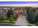 Beautiful exterior of home with meticulous landscaping and a long driveway on a large lot at 12147 S Shady Pine Ct, Parker, CO 80134