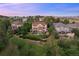 Aerial view of the luxury home, showcasing landscaping, multi-level deck, and serene neighborhood setting at 12147 S Shady Pine Ct, Parker, CO 80134