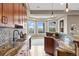 A wet bar with wood cabinets, granite countertops, mosaic backsplash and pendant lighting inside the finished basement at 12147 S Shady Pine Ct, Parker, CO 80134