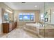 Bathroom with a soaking tub, a glass enclosed shower, a marble tile floor and a large mirror with a granite topped vanity at 12147 S Shady Pine Ct, Parker, CO 80134