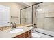 Bathroom with a shower-tub combo with tiled surround, a vanity with a dark wooden cabinet, and a neutral colored countertop at 12147 S Shady Pine Ct, Parker, CO 80134