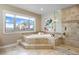 Bright bathroom featuring a soaking tub, tiled shower, and a large window with picturesque views at 12147 S Shady Pine Ct, Parker, CO 80134