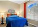 Comfortable bedroom with a blue quilted bedspread, bright natural light, and contemporary decor at 12147 S Shady Pine Ct, Parker, CO 80134