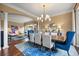 This dining room features a stunning chandelier, wood floors, and easy access to the living area at 12147 S Shady Pine Ct, Parker, CO 80134
