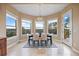 This dining room offers natural light and expansive views with access to the outdoor deck at 12147 S Shady Pine Ct, Parker, CO 80134