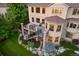 Stunning exterior showcasing deck, stone columns, professional landscaping, and scenic wooded backdrop at 12147 S Shady Pine Ct, Parker, CO 80134