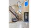 Spacious foyer with staircase, a statement door, and elegant tile flooring at 12147 S Shady Pine Ct, Parker, CO 80134