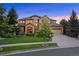 Charming home with a manicured lawn, mature trees, and a welcoming front entryway at 12147 S Shady Pine Ct, Parker, CO 80134