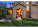 Front exterior of home with meticulous landscaping including custom shrubbery and stone accents at 12147 S Shady Pine Ct, Parker, CO 80134