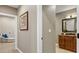 Hallway view to bathroom, showing neutral paint, and doorframes and door to the living room at 12147 S Shady Pine Ct, Parker, CO 80134