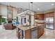 Open concept kitchen with a large center island, stainless steel appliances, and barstool seating at 12147 S Shady Pine Ct, Parker, CO 80134