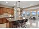 This modern kitchen offers an eat-in area, stainless appliances, an island, and granite countertops at 12147 S Shady Pine Ct, Parker, CO 80134