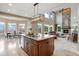 Open-concept kitchen with granite countertops, stainless appliances, and views into living room and dining area at 12147 S Shady Pine Ct, Parker, CO 80134