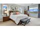 Serene main bedroom with neutral tones, a large bed, and windows providing natural light with mountain views at 12147 S Shady Pine Ct, Parker, CO 80134