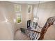 Grand staircase with decorative iron railings, leading to the main level with abundant natural light at 12147 S Shady Pine Ct, Parker, CO 80134