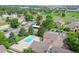 Aerial view of community pool, tennis court, mature landscaping, and residential buildings at 10251 W 44Th Ave # 7-106, Wheat Ridge, CO 80033