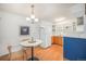 Bright kitchen featuring white appliances, wood cabinets, open shelving, and dining area at 10251 W 44Th Ave # 7-106, Wheat Ridge, CO 80033