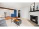 Bright living room with a fireplace, hardwood floors, and an open concept to the dining area at 10251 W 44Th Ave # 7-106, Wheat Ridge, CO 80033