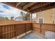 Outdoor patio with wood fence, exposed rafters, and a concrete floor offers private relaxation at 10251 W 44Th Ave # 7-106, Wheat Ridge, CO 80033