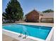 Community pool surrounded by well-maintained landscaping and residential buildings creates a refreshing oasis at 10251 W 44Th Ave # 7-106, Wheat Ridge, CO 80033