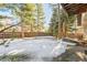 Large backyard with snow covered ground and tall trees at 118 S Eldridge Way, Golden, CO 80401