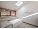 Bathroom with bathtub, skylight, and built-in shelving at 118 S Eldridge Way, Golden, CO 80401