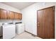 Laundry room with washer, dryer, and wood cabinets at 118 S Eldridge Way, Golden, CO 80401