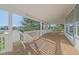 Covered back porch with wood floors and white railings, offering a relaxing outdoor space at 10125 Quarry Hill Pl, Parker, CO 80134