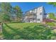 Expansive backyard featuring a large, multi-level deck, manicured lawn, and mature trees at 10125 Quarry Hill Pl, Parker, CO 80134