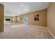 Open basement area with carpet flooring, a large window, and backyard access at 10125 Quarry Hill Pl, Parker, CO 80134