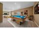 Finished basement featuring a pool table, movie posters, and access to an outdoor space at 10125 Quarry Hill Pl, Parker, CO 80134