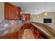 Wet bar featuring wooden cabinetry, granite countertops, and stainless steel appliances at 10125 Quarry Hill Pl, Parker, CO 80134