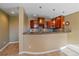 Wet bar featuring granite countertops, tile backsplash, and wooden cabinets at 10125 Quarry Hill Pl, Parker, CO 80134