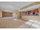 Spacious basement area with carpet flooring, and a full bar with wooden cabinetry at 10125 Quarry Hill Pl, Parker, CO 80134