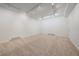 Spacious basement with neutral carpeting and versatile track lighting; ready for customization at 10125 Quarry Hill Pl, Parker, CO 80134