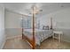 Cozy bedroom featuring a four-poster bed, large window, and neutral decor at 10125 Quarry Hill Pl, Parker, CO 80134