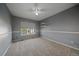 Neutral carpeted bedroom featuring a window, a ceiling fan, and two electrical outlets at 10125 Quarry Hill Pl, Parker, CO 80134