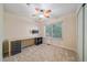 Bright bedroom features a ceiling fan, and a built-in desk next to a window at 10125 Quarry Hill Pl, Parker, CO 80134