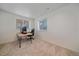Neutral bedroom with a large window, and desk that can be used as a home office at 10125 Quarry Hill Pl, Parker, CO 80134