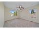Bedroom with neutral carpeting, two large windows, and a ceiling fan at 10125 Quarry Hill Pl, Parker, CO 80134