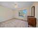 Spacious bedroom with neutral carpeting, a large window, and a ceiling fan at 10125 Quarry Hill Pl, Parker, CO 80134
